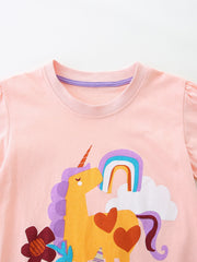 Pink cotton toddler t-shirt with unicorn, rainbow, and cloud graphic.