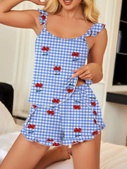 Ruffled cami and shorts set in blue gingham with cherry print, featuring ruffle trim.