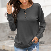 Gray henley sweatshirt with drop shoulders and a button placket.