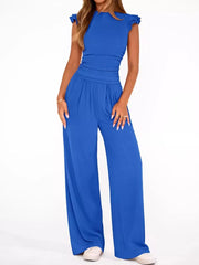 Sky blue ruffled cap sleeve maternity jumpsuit with ruched waist and wide legs.
