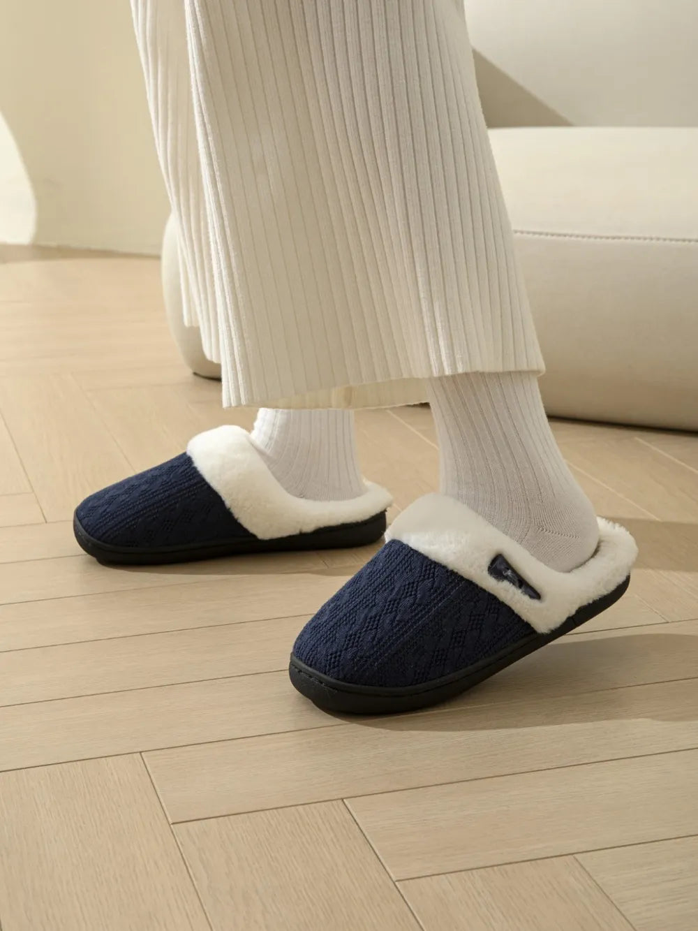 Dark Navy cable knit shearling house slippers with white trim.