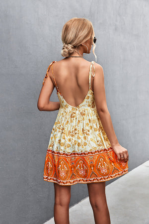 Bohemian print mini dress in light yellow with tie straps and backless design