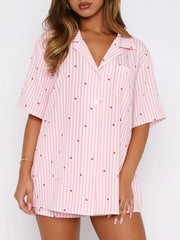 Blush pink striped pajama set with red hearts, collared button-up top and shorts.