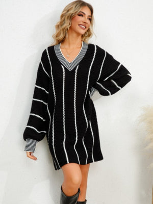 Black oversized sweater dress with white vertical stripes, V-neck, and balloon sleeves.