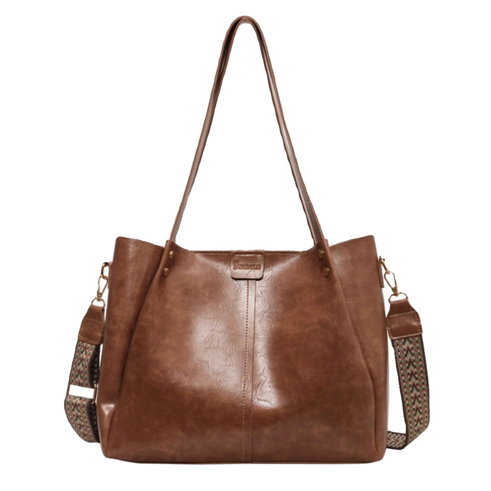 Large distressed brown leather shoulder bag with a patterned detachable strap.