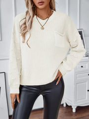 Ivory knit sweater with textured sleeves and a chest pocket.