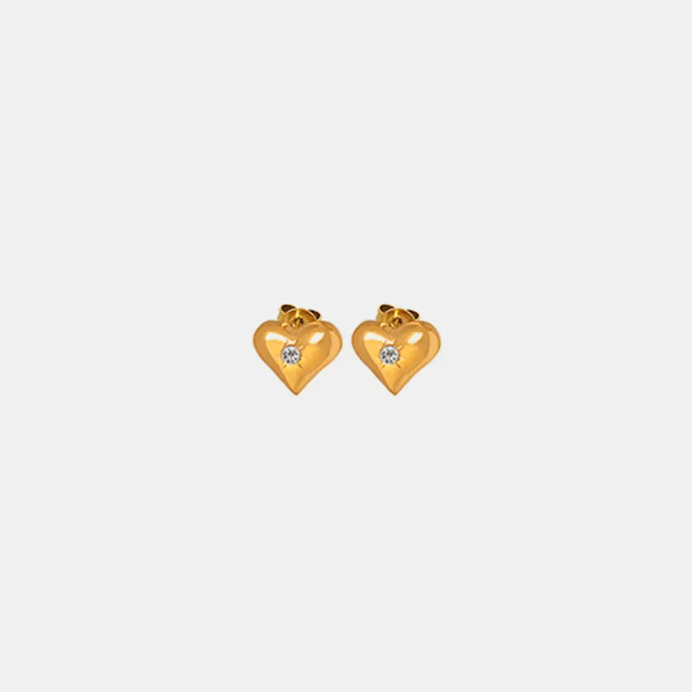 Gold heart stud earrings with a single clear gem detail.