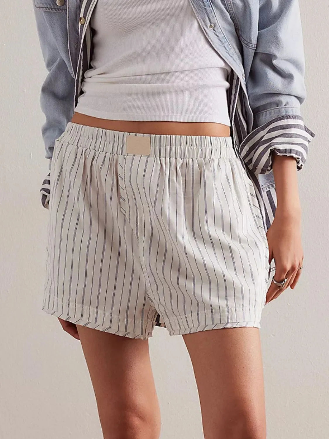 White boxer shorts with navy pinstripes and an elastic waistband.