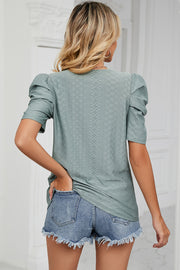 Perforated puff sleeve top in light green with textured diamond pattern.