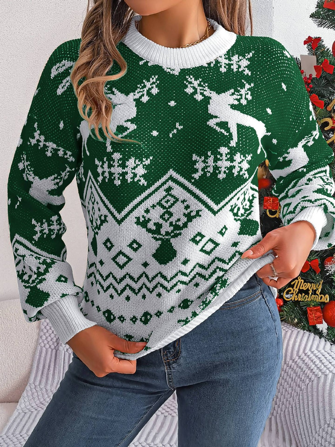 Green acrylic knit sweater with reindeer and snowflake Fair Isle pattern.