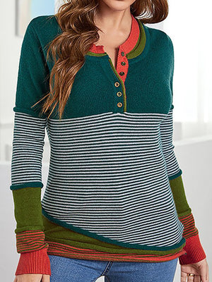 Colorblock henley knit shirt with stripes and button detail. Orange-red trim.