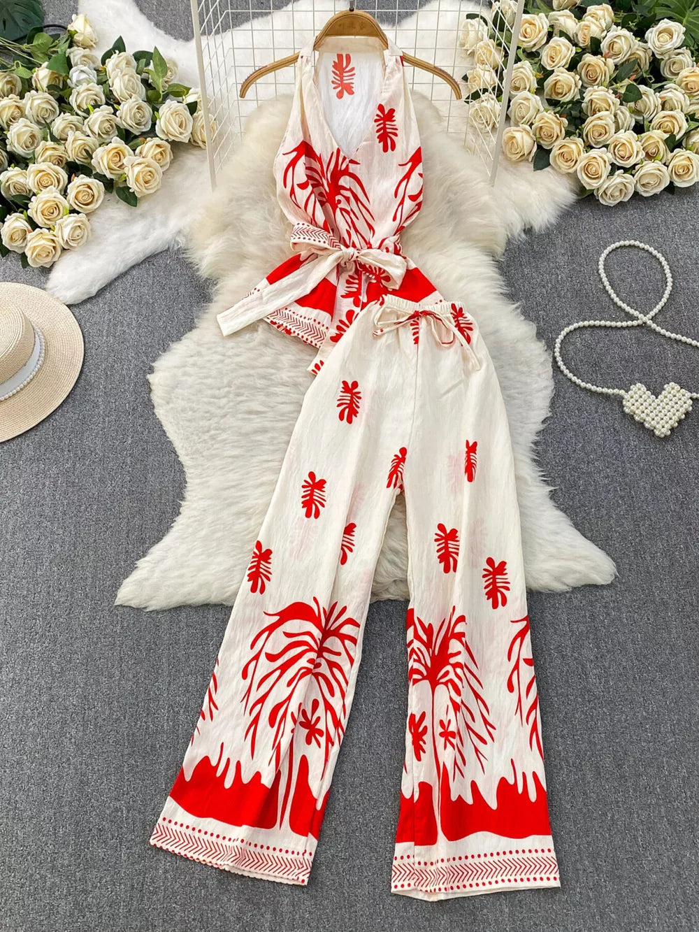 Red tropical print halter top and wide leg pants set with belted detail.