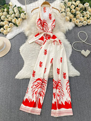 Red tropical print halter top and wide leg pants set with belted detail.