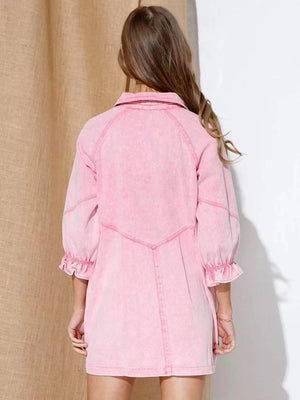 Blush pink denim button-down dress with ruffled cuffs and collar.