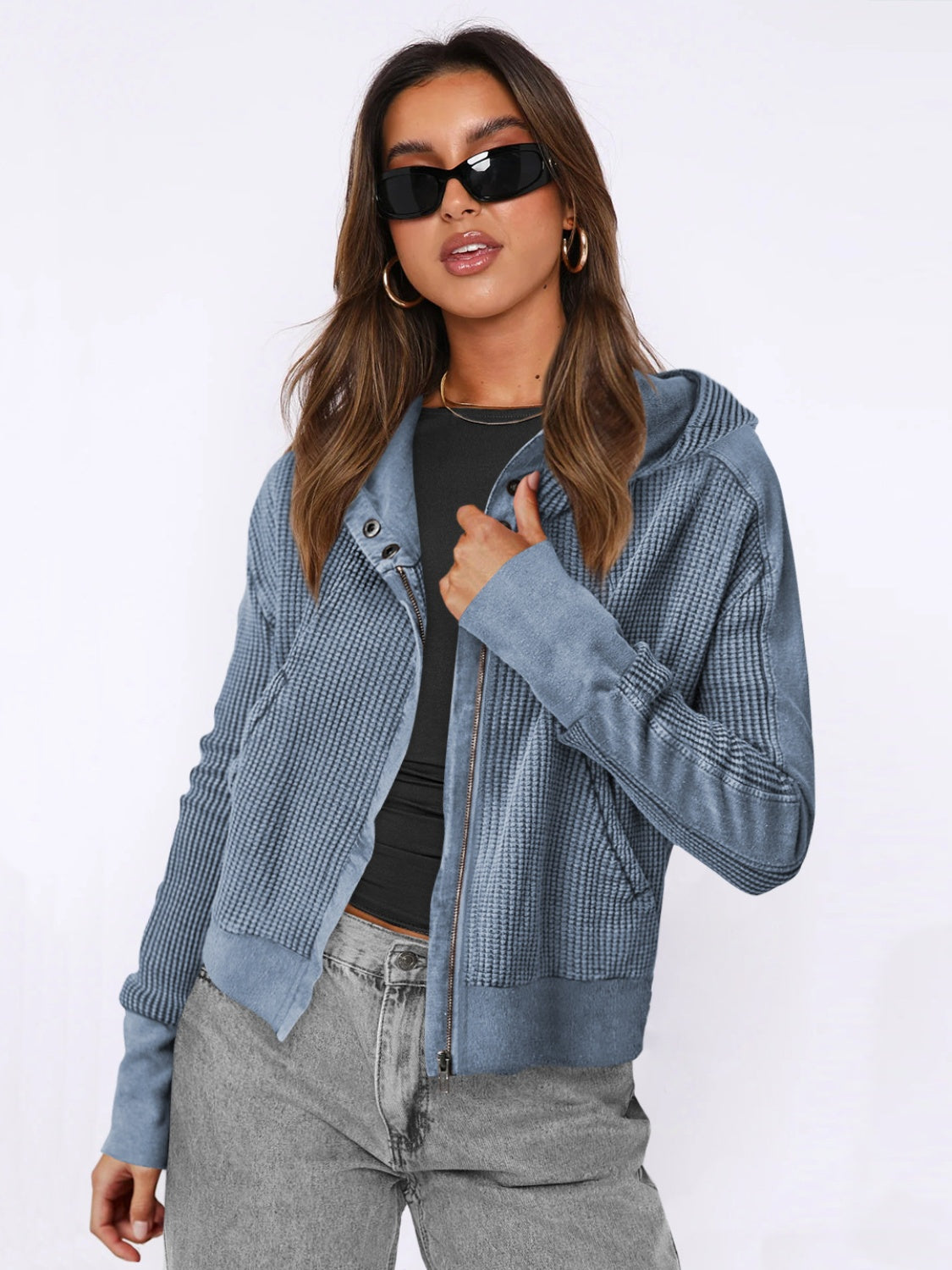 Dusty blue waffle knit snap-front cropped hoodie with zip closure and hood.