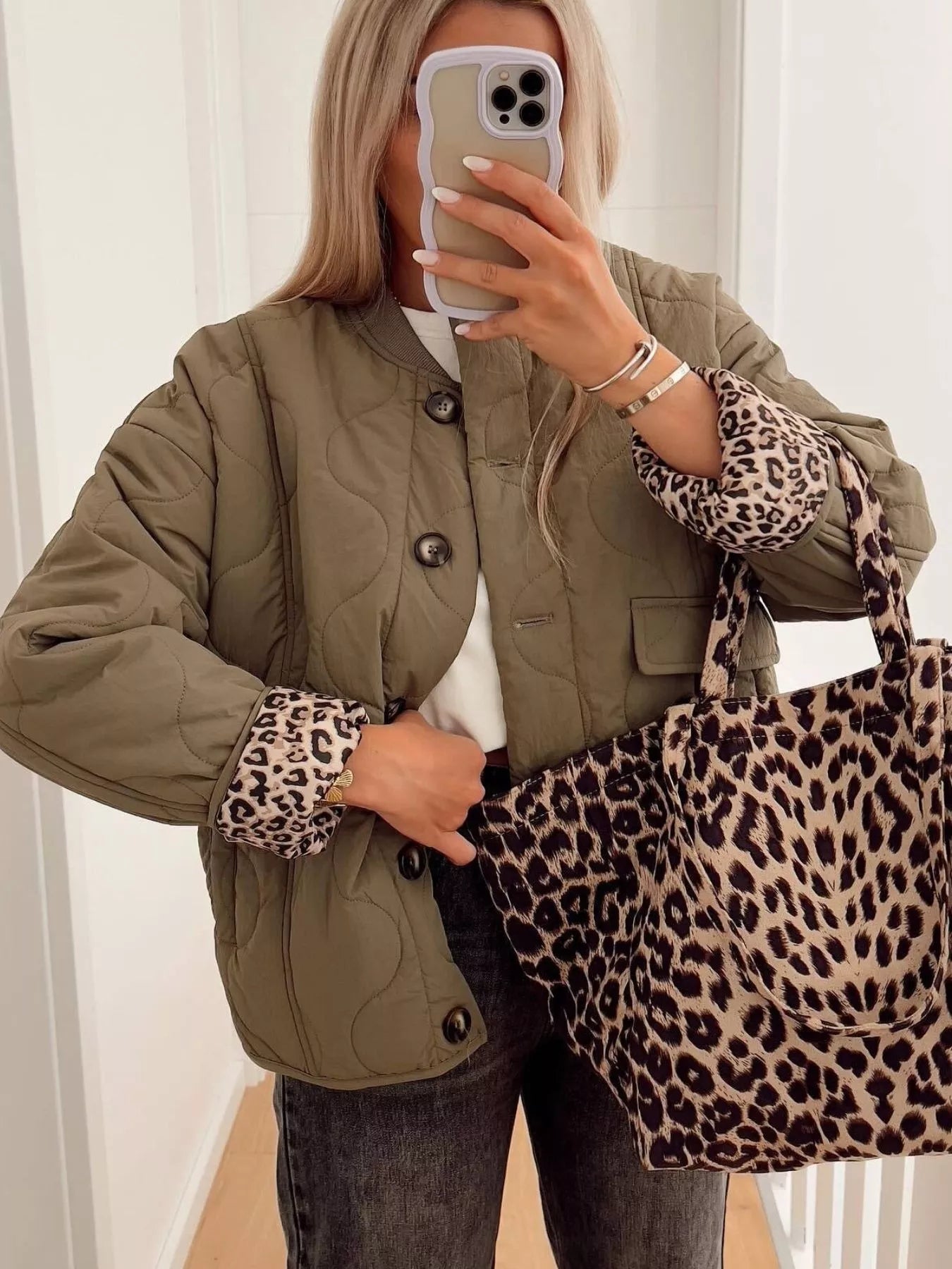 Moss green quilted button-down jacket with leopard print cuffs and matching tote bag.