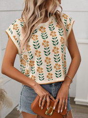 Floral knit sleeveless top in cream with orange flowers and green leaves pattern.