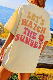 Oversized khaki t-shirt with "Let's Watch The Sunset" graphic print in retro font.