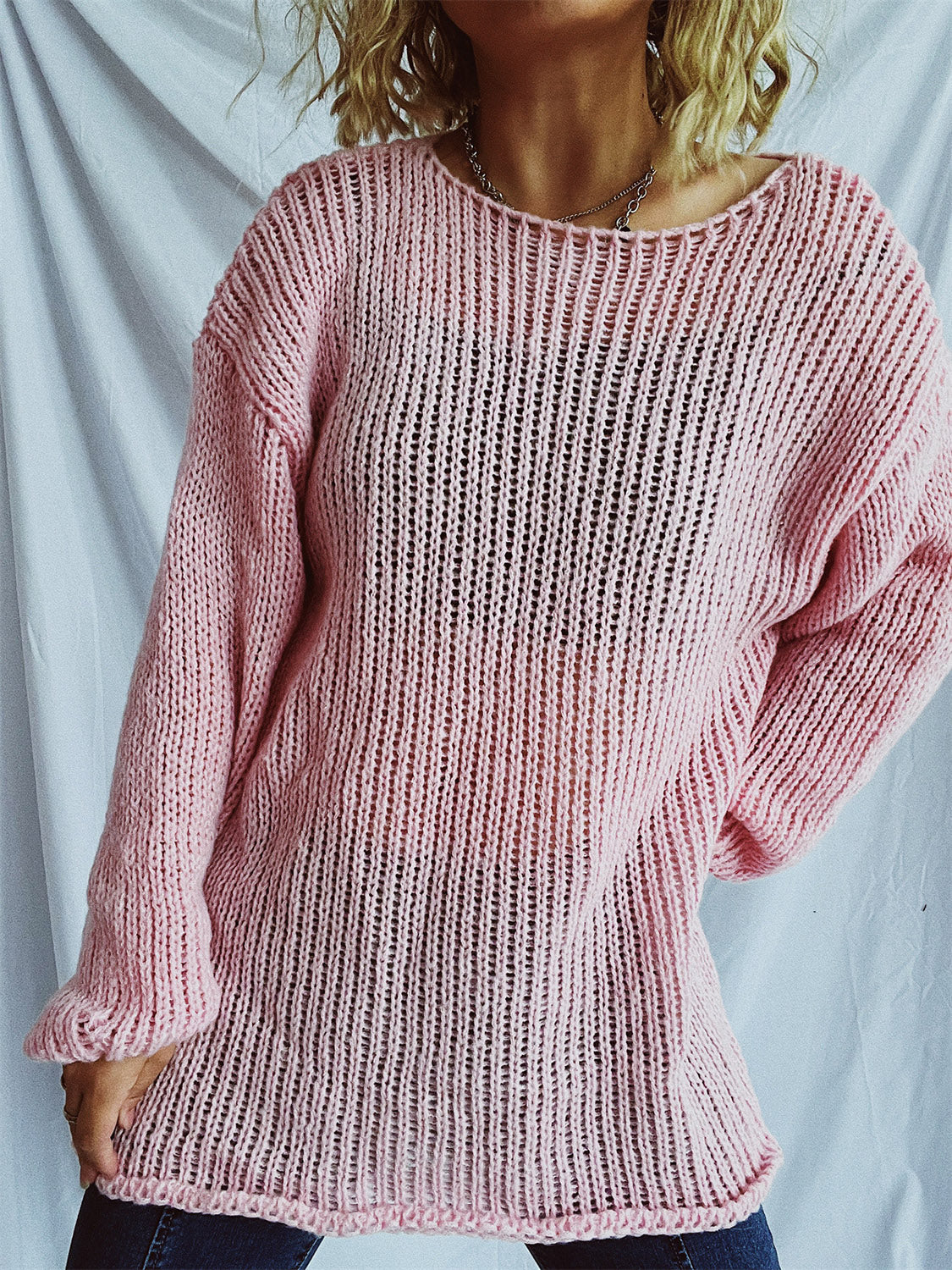 Blush pink open-knit slouchy boatneck pullover sweater with a relaxed fit.