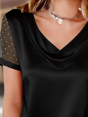 Black cowl neck blouse with sheer, rhinestone-embellished sleeves