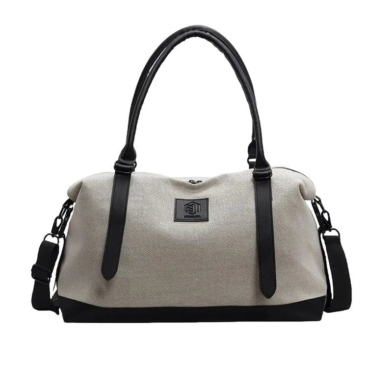 Canvas weekend holdall duffel bag in Khaki with black trim and straps, featuring a logo patch.