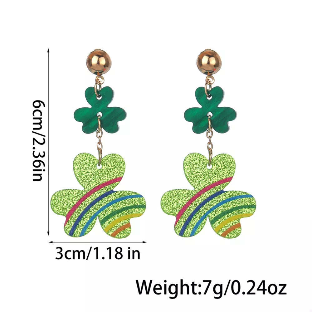 Gold dangle earrings with green glitter clover charms and colorful stripe details