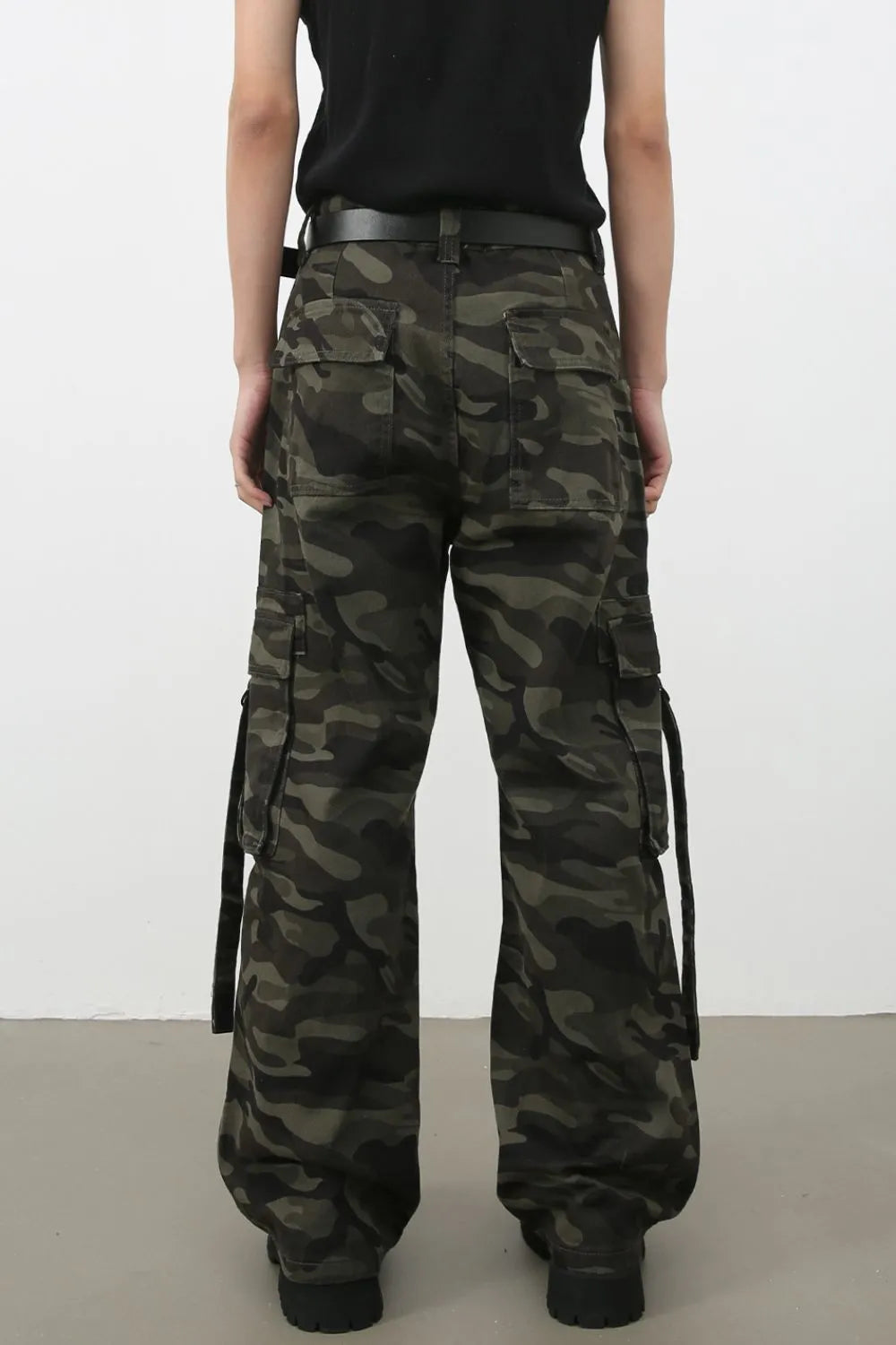 Wide-leg camo cargo pants with belt detail and multiple pockets.