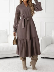 Coffee brown midi dress with ruffle hem, long sleeves, tie waist, and mock neck.