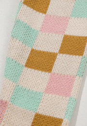 Colorblock checkerboard knit sweater in blush pink, beige, and mint green acrylic.