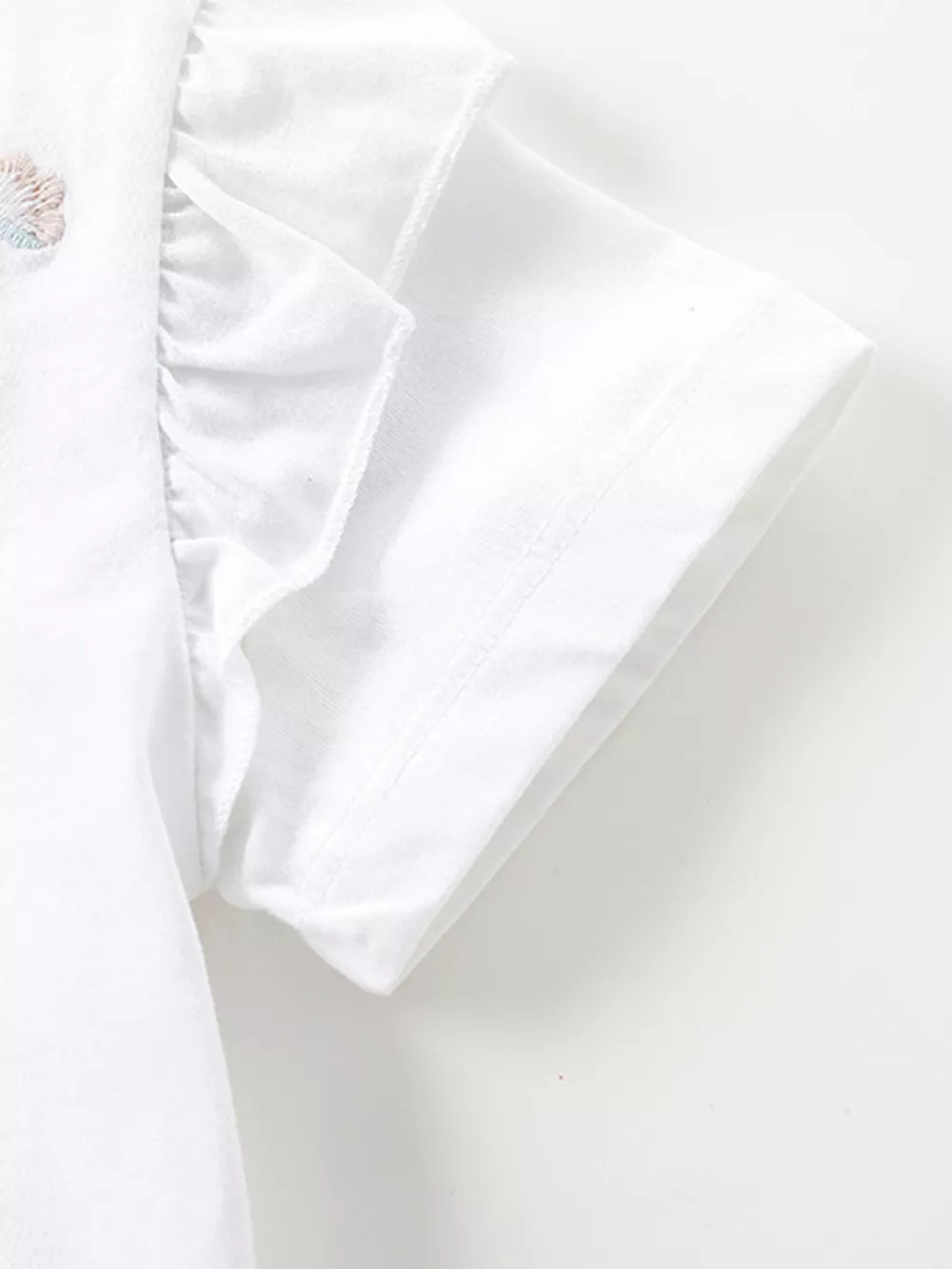White baby dress with ruffled sleeves and a subtle embroidered butterfly detail.