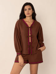 Brown linen tie-front pajama set with scallop trim and balloon sleeves.