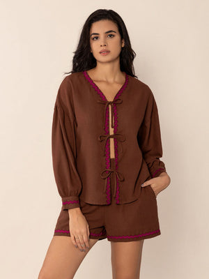 Brown linen tie-front pajama set with scallop trim and balloon sleeves.