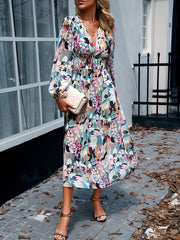 Floral print midi dress with V-neck, long sleeves, and smocked waist.