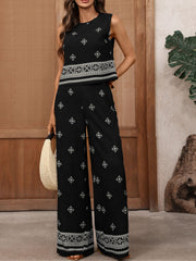 Black sleeveless top and wide-leg pants set with geometric print and ornate border detail.