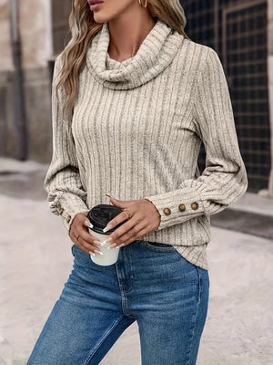 Tan ribbed cowl neck sweater with button cuff detail and long sleeves.