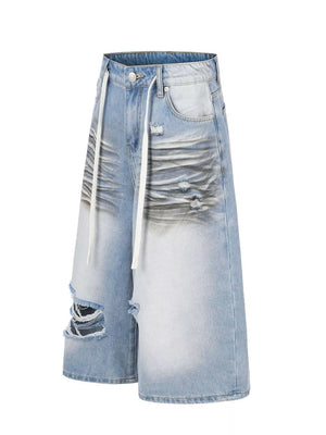 Distressed light blue cotton wide-leg capri jeans with white drawstring and ripped details.