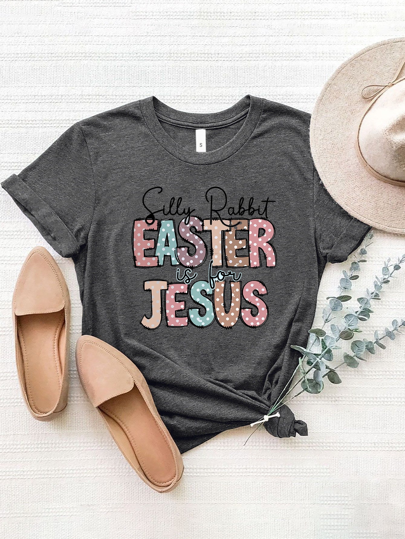Dark gray Easter graphic tee with pastel polka dot text that reads "Silly Rabbit EASTER is for JESUS".