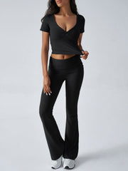 Black ruched waistband flared lounge pants and a matching short-sleeve V-neck top.