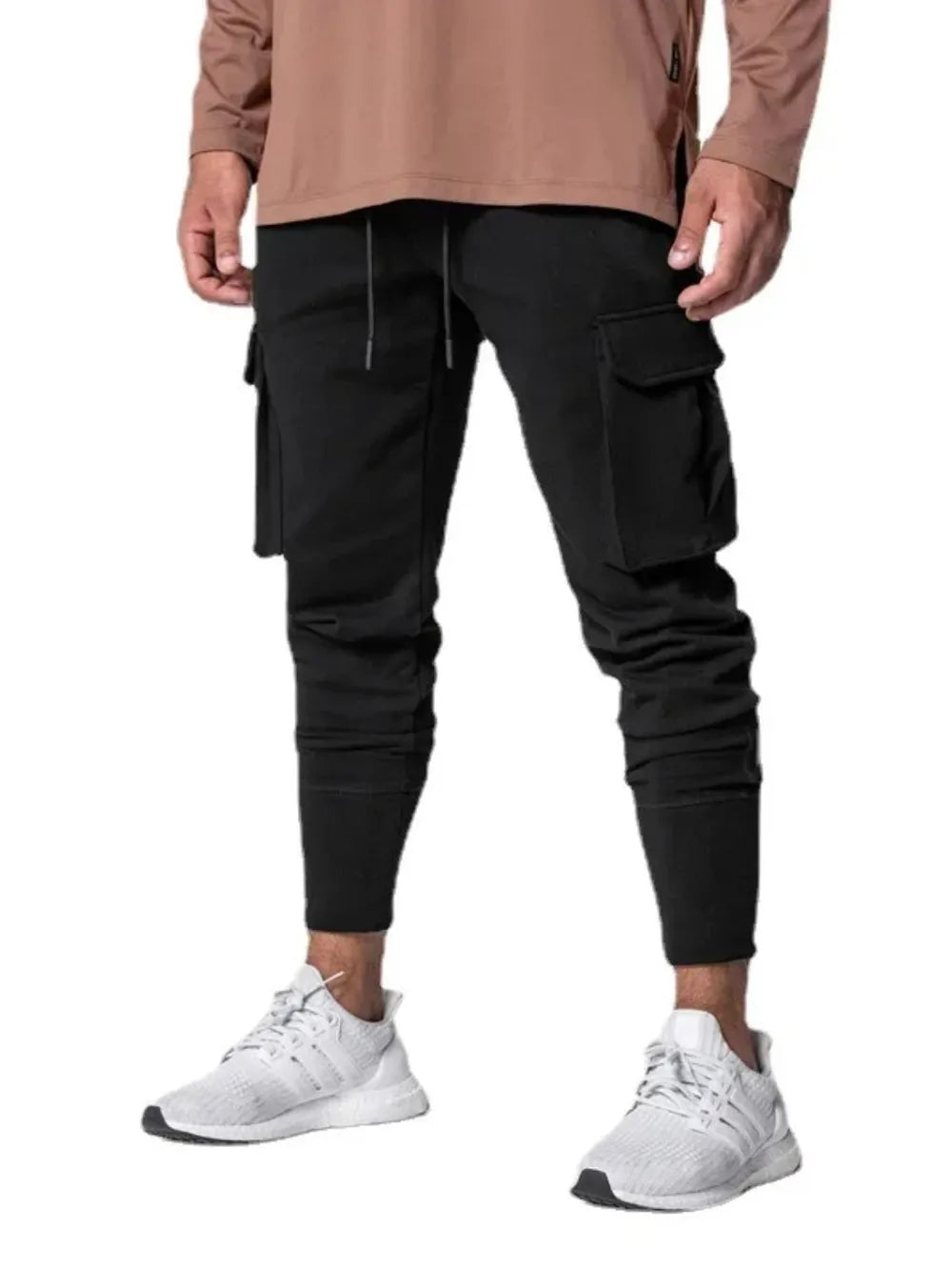 Black Tech-Knit Cargo Joggers with drawstring waist and zip pocket detail.