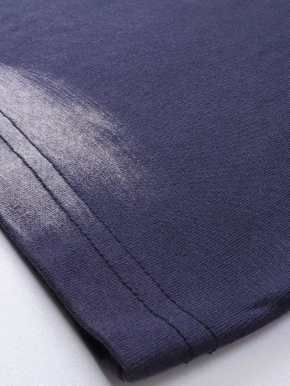 Men's dark navy t-shirt with abstract brushstroke detail and visible stitching.