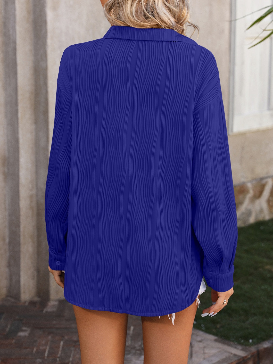 Textured pleat oversized button-down shirt in royal blue with long sleeves and a collared neckline.