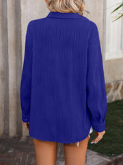 Textured pleat oversized button-down shirt in royal blue with long sleeves and a collared neckline.