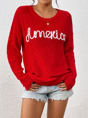 Red knit sweater with embroidered "America" text, crew neck, long sleeves.