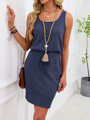 Navy blue sleeveless waffle-knit drawstring dress with a tasseled tie.