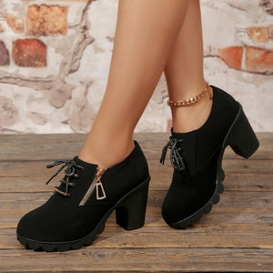 Black lace-up high heel pumps with a side zipper and chunky block heel.