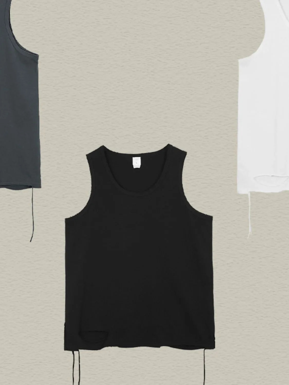 Black raw edge scoop neck tank top with distressed hem detail