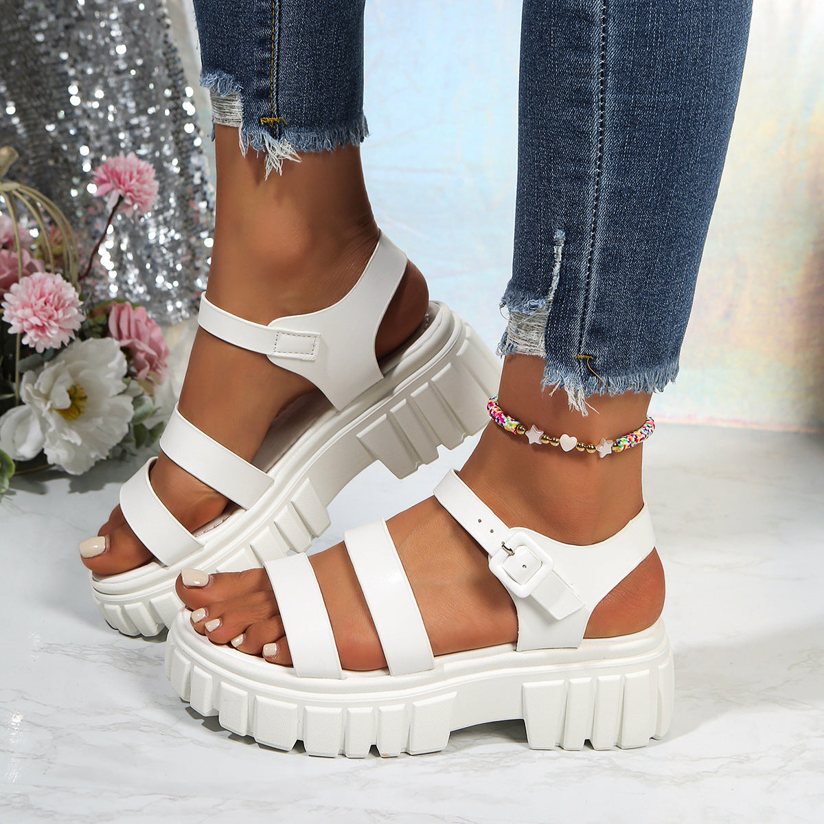 White open-toe platform sandals with three straps and buckle closure.