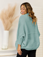Teal acrylic knit cocoon cardigan with pockets and cuffed sleeves.