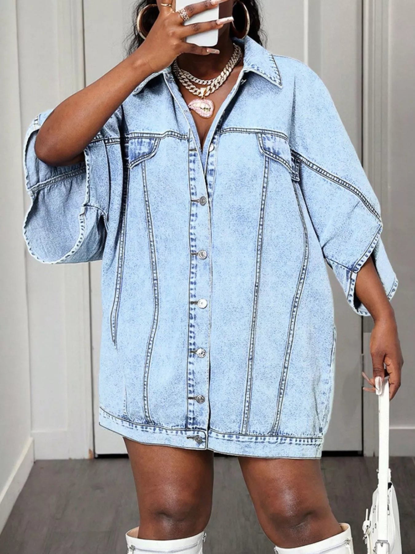 Sky blue denim batwing dress with button front and wide sleeves.