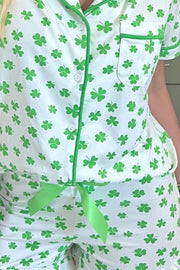 Green shamrock print silk pajama set with white and green trim.